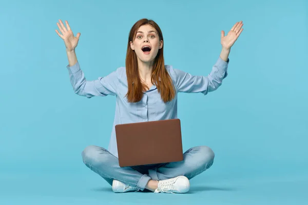 stock image woman with laptop learning internet online education blue background