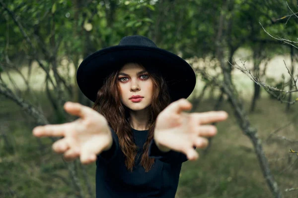 Woman in black witch costume in forest nature posing — Stock Photo, Image