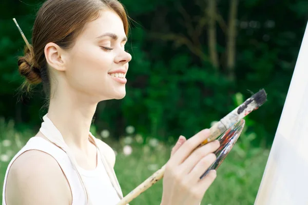 Woman artist paints palette easel nature drawing — Stock Photo, Image