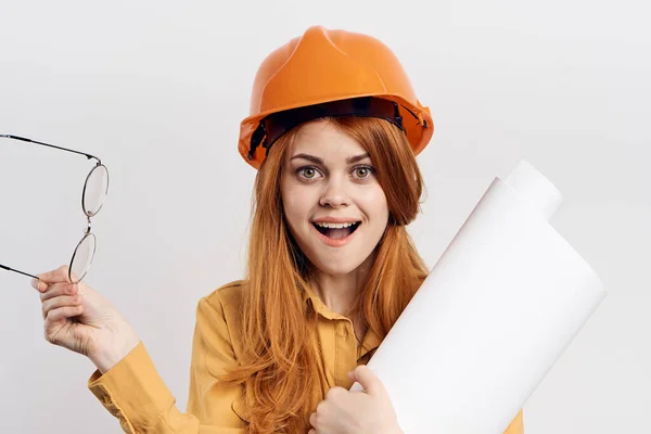 Female engineer in orange hard hat blueprints architect — Stock Photo, Image