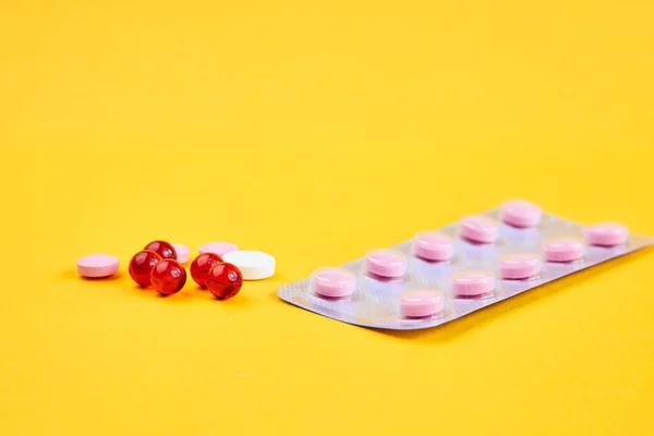 Píldora embalaje vitaminas antibióticos farmacéutico amarillo fondo — Foto de Stock
