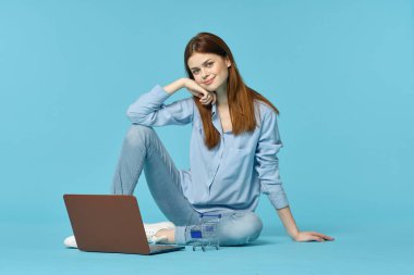 Dizüstü bilgisayarı olan kadın internet eğitimi mavi arka plan