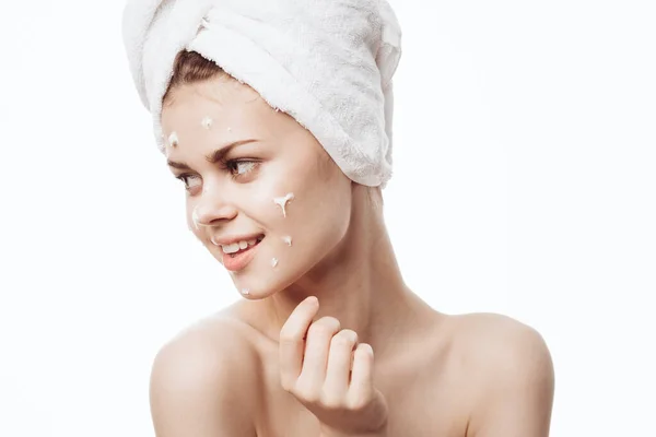 Cheerful woman with a white towel on her head face cream skin care — Stock Photo, Image