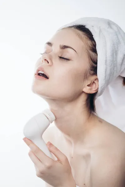 Pretty woman with towel on head close-up facial massage — Stock Photo, Image