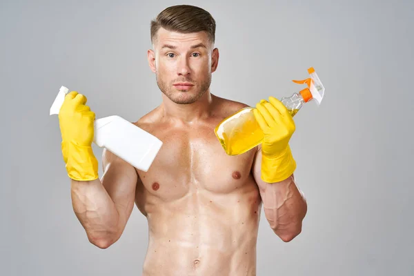 Man with pumped up muscular body detergent rubber service gloves — Stock Photo, Image