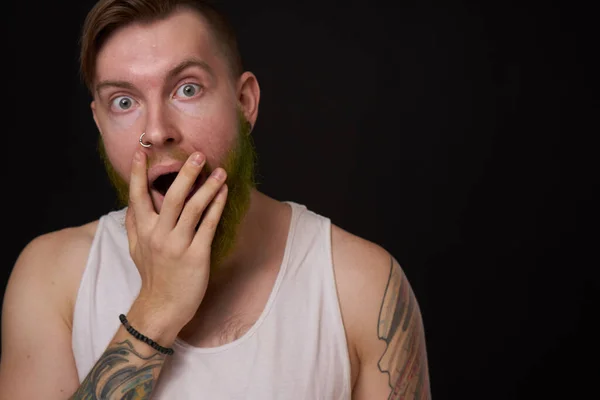 Homem barbudo elegante em uma camiseta branca com tatuagens em seus braços moda — Fotografia de Stock