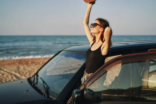 Frau am Strand ist mit Auto mit Sonnenbrille unterwegs — Stockfoto