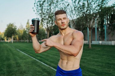 Parktaki sporcu kaslı adam sağlıklı gıda zindeliği