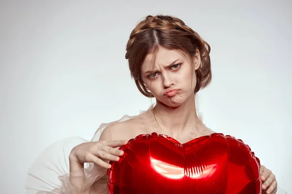 stock image portrait of a woman in a dress balloon Valentines Day light background