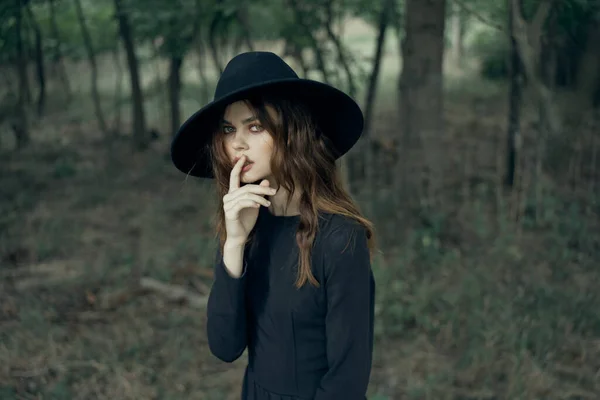 Woman witch in black hat in the forest posing fantasy — Stock Photo, Image