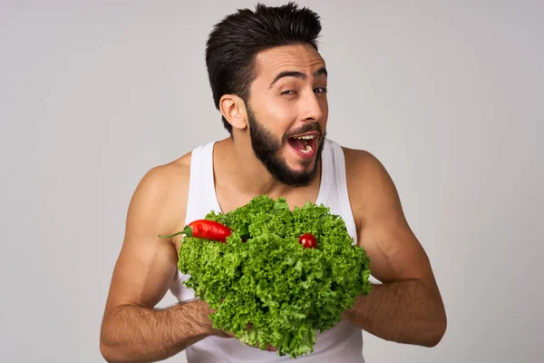 흰 티셔츠 상추 잎 채소 건강 한 음식을 먹는 수염 남자 — 스톡 사진
