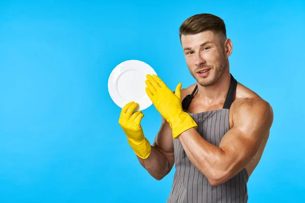 Vaatwasser rubberen handschoenen plaat in handen blauwe achtergrond — Stockfoto