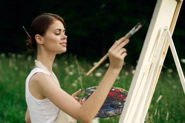 Mulher alegre artista pintando um quadro ao ar livre arte criativa — Fotografia de Stock