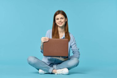 Dizüstü bilgisayarı olan kadın internet eğitimi mavi arka plan