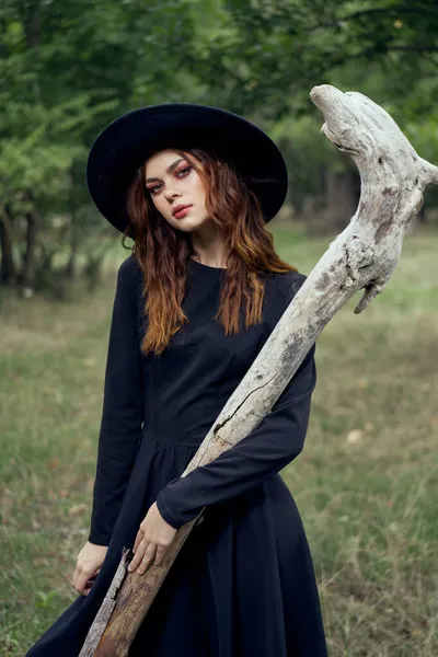 Woman in black witch costume in forest nature posing — Stock Photo, Image