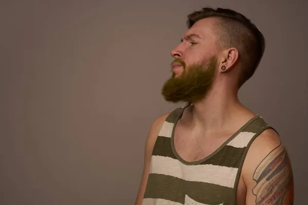 Homme à la mode avec des tatouages sur ses bras style coiffure studio confiance en soi — Photo