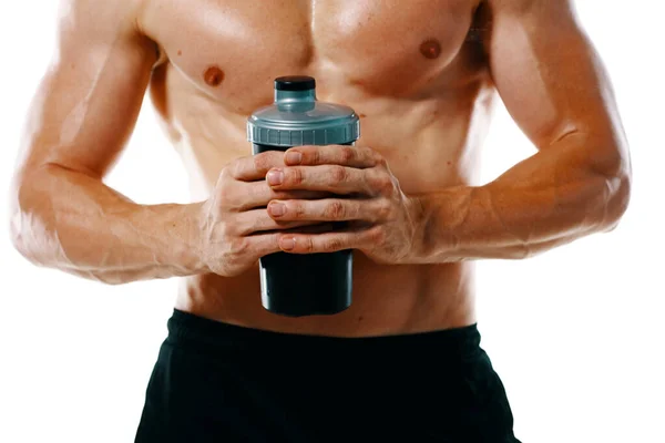 Athletic man with a pumped-up torso drink bottle sportspit — Stock Photo, Image