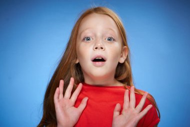 neşeli kızıl saçlı kız çocukluk mavi arka planı