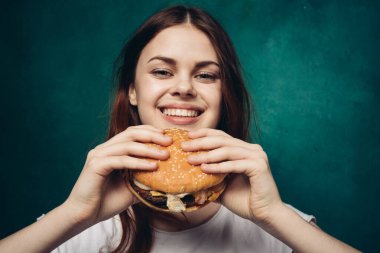 Hamburger yiyen bir kadın.