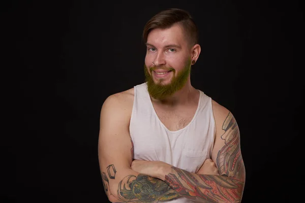 Стильний бородатий чоловік у білій футболці з татуюваннями на моді його рук — стокове фото
