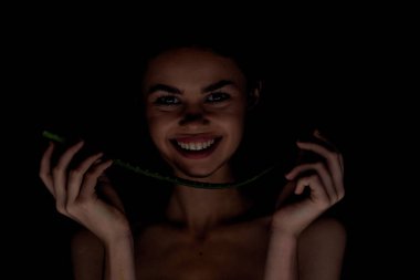 Çıplak omuzlu bir kadın. Açık tenli, aloe organik koyu arkaplan.