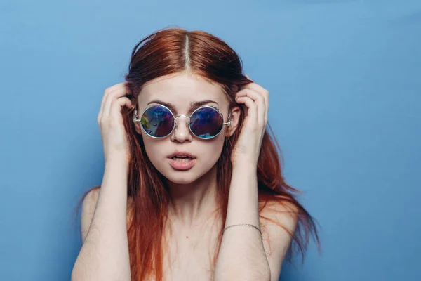 Attractive woman with bare shoulders fashionable glasses blue background — Stock Photo, Image