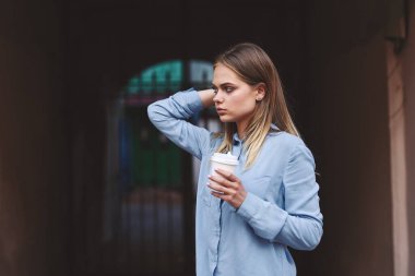 Güzel bir kadın kahve fincanı tarzı yürür.