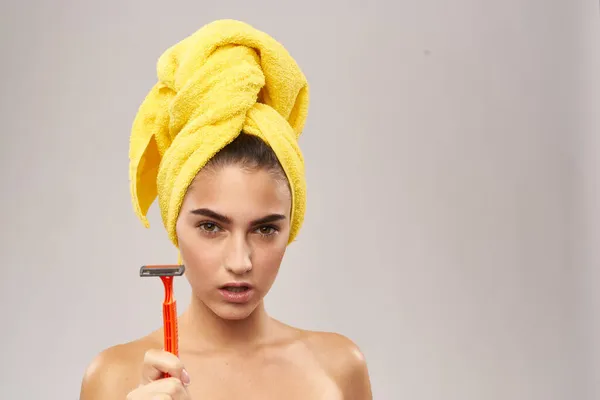 Csinos nő egy sárga törölköző a fején borotválkozás — Stock Fotó