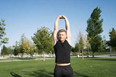 Yaz antrenmanı boyunca parktaki kaslı adam ve sporcu.