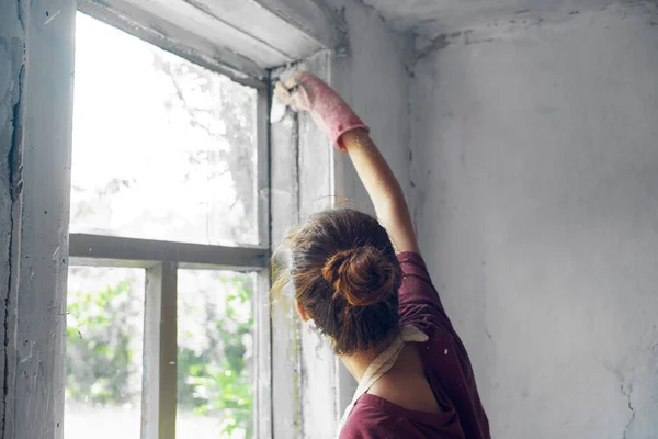 Woman with brush paint window home renovation interior — Stock Photo, Image