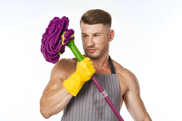 Muscular man in a gray apron with a mop posing — Stock Photo, Image