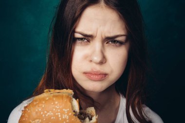 Hamburger yiyen bir kadın.