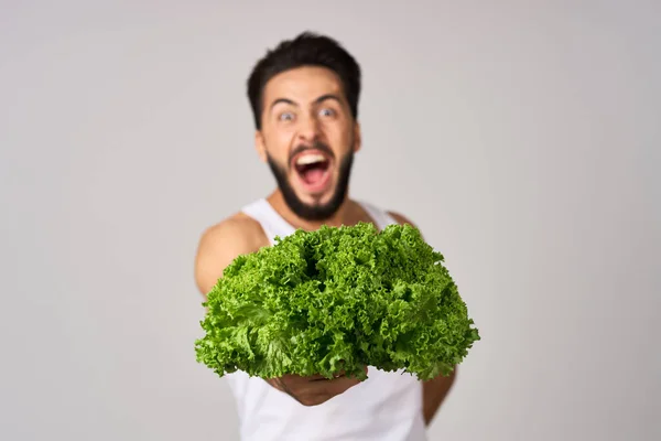 Cheerful man in a white t-shirt lettuce leaves healthy food — Stock Photo, Image