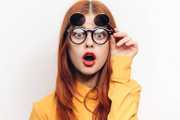 glamorous woman sunglasses red hair light background
