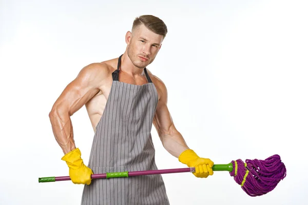Desportivo homem no avental esfregona posando limpeza tarefas domésticas — Fotografia de Stock