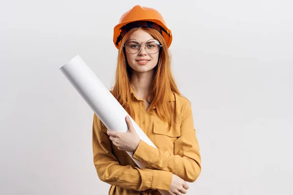 Female engineer in orange hard hat blueprints architect — Stock Photo, Image