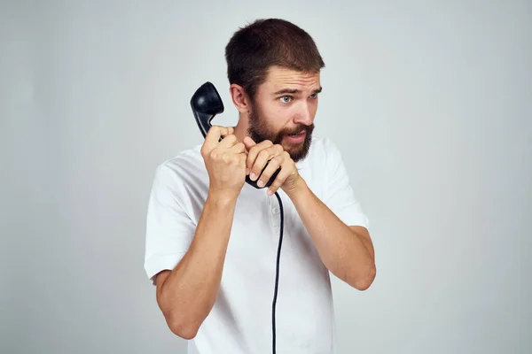 Man with home phone in hands technology light background emotions — Stock Photo, Image