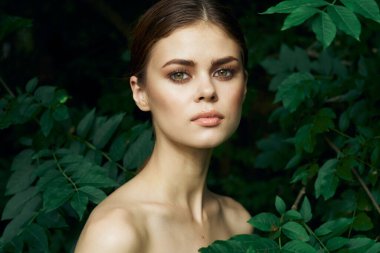 Güzel kadın yeşil yapraklar. Temiz ten. Yaz modeli.