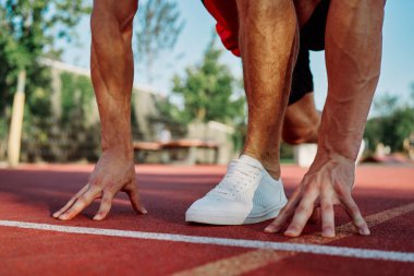 Spor sahası egzersizlerinde kaslı sporcular.