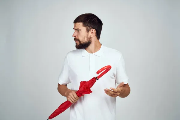 Homem com guarda-chuva nas mãos emoções posando fundo claro — Fotografia de Stock