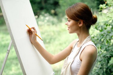 Neşeli kadın sanatçı doğa yaratıcı sanatı canlandırır.