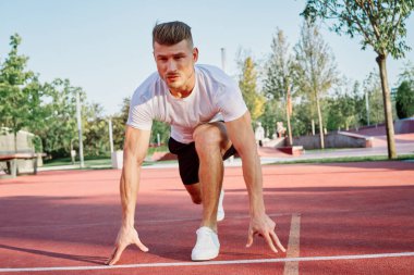 Adam dışarıda oyun sahasında egzersiz yapıyor.