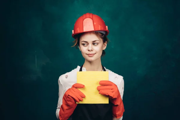 Woman in black apron orange hard hat protection cleaning — Stock Photo, Image