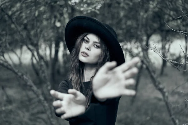 Woman in black witch costume in forest nature posing — Stock Photo, Image