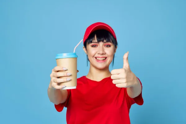 Kobieta w czerwonym mundurze filiżanka kawy niebieski tło zabawy — Zdjęcie stockowe