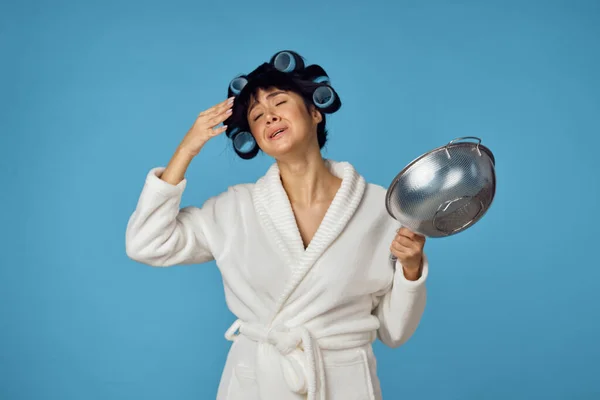 Huisvrouw in witte jas huishoudelijk werk schoonmaken blauwe achtergrond — Stockfoto