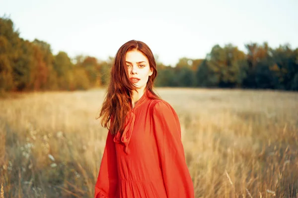 Mignonne femme aux cheveux roux en robe rouge dans le champ nature été — Photo