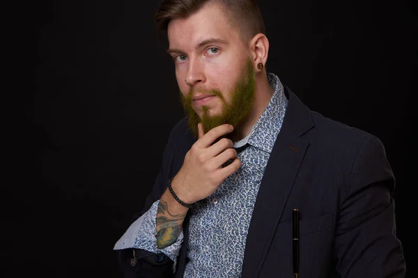 Fashionable business man in a jacket with a beard posing — Stock Photo, Image