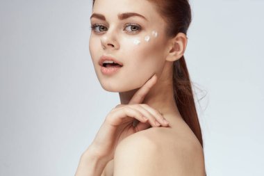 Güzel kızıl saçlı kadın temiz cilt sağlığı açık arka plan pozu veriyor