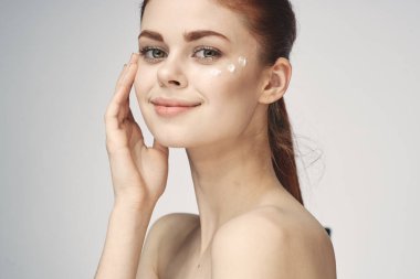 Güzel kızıl saçlı kadın temiz cilt sağlığı açık arka plan pozu veriyor